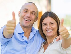 Older couple giving thumbs up