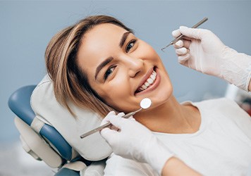 Woman in white t-shirt about to have dental exam